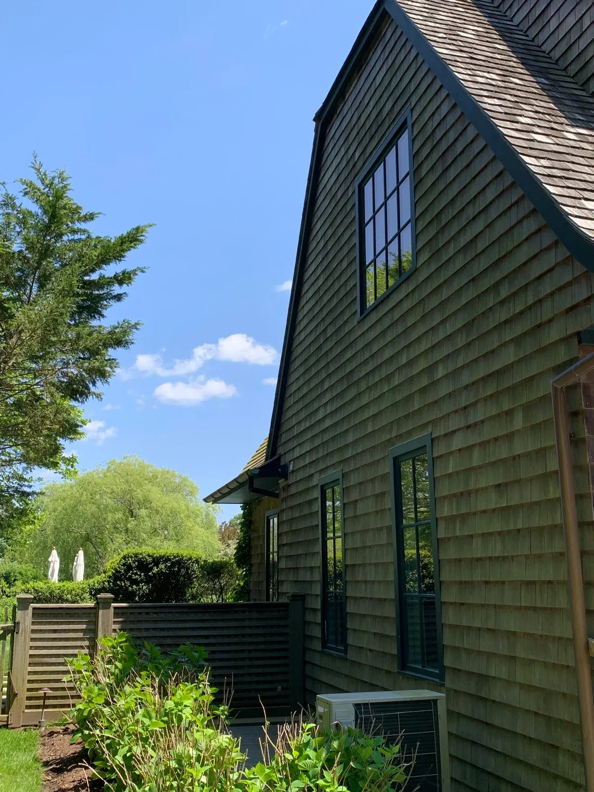 Wooded, shaded cedar shake home exterior