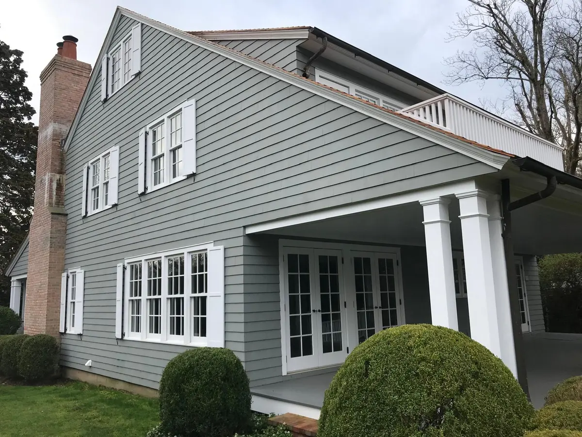 Painted gray-green siding with white porch columns