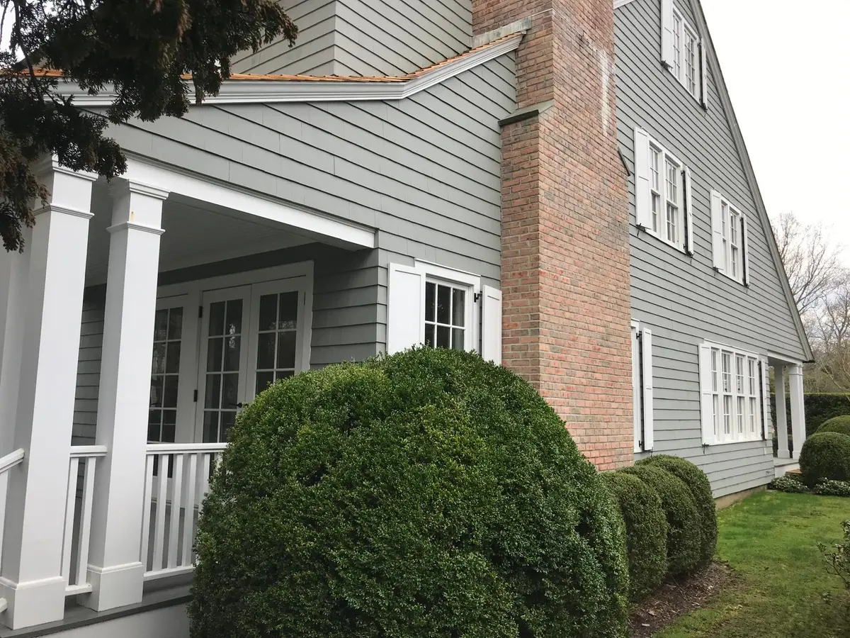 Exterior paint job on a home with brick chimney accents