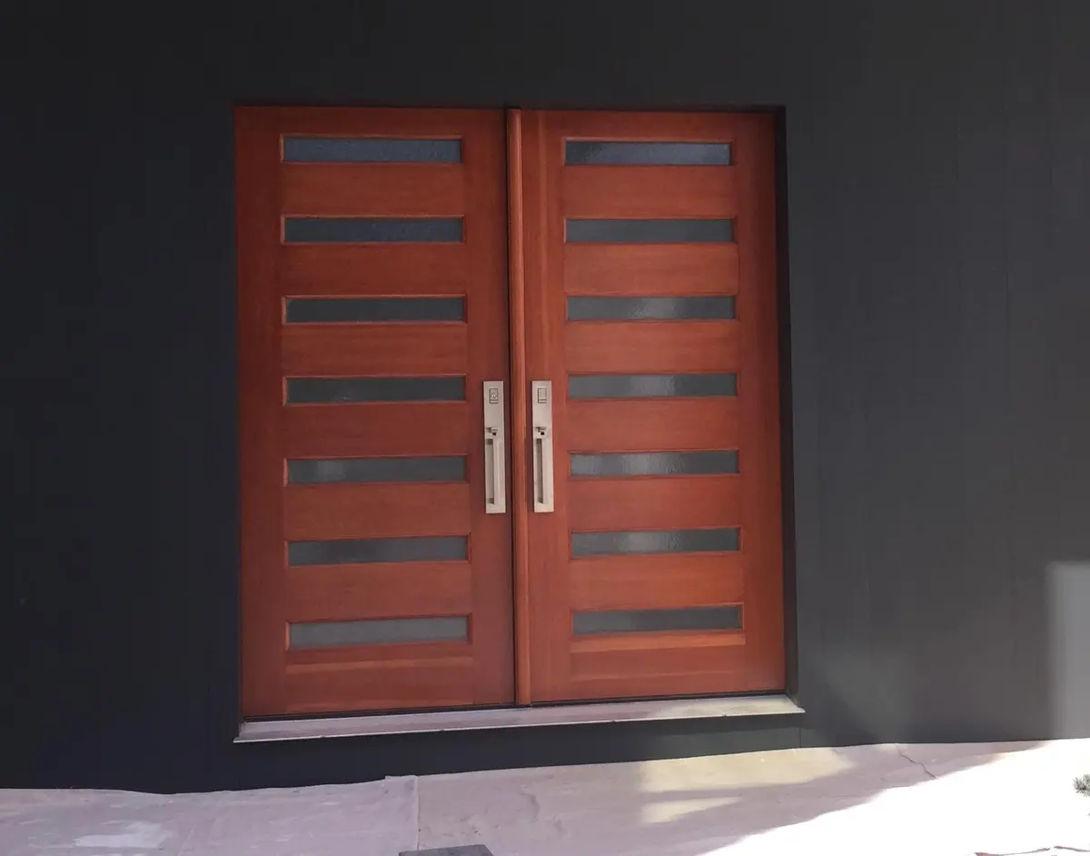 Modern dark navy exterior accent wall with wood double doors