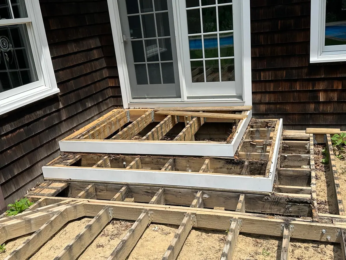 Deck framing in progress by a window and door