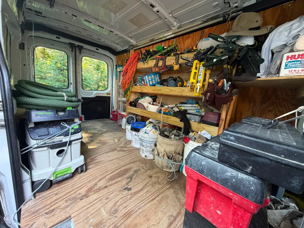 Organized tools and materials inside the Tovar's Painting van
